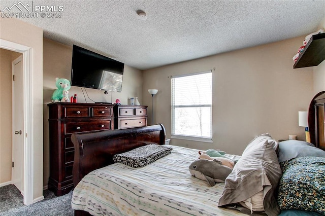 carpeted bedroom with a textured ceiling