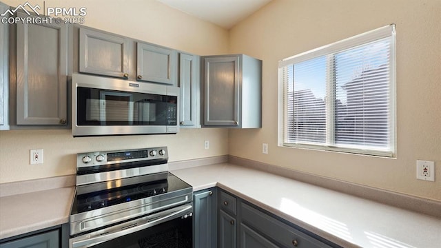 kitchen with appliances with stainless steel finishes and gray cabinetry