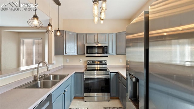 kitchen featuring sink, light tile patterned floors, appliances with stainless steel finishes, gray cabinets, and pendant lighting