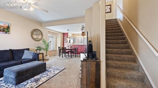 living room featuring carpet and ceiling fan