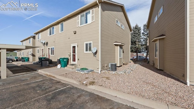 rear view of property with central AC unit