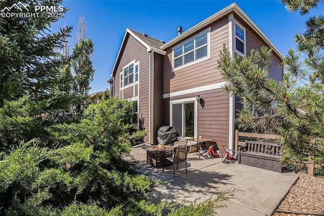 back of house featuring an outdoor fire pit and a patio area