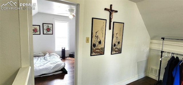 bedroom featuring ceiling fan, dark hardwood / wood-style flooring, and vaulted ceiling