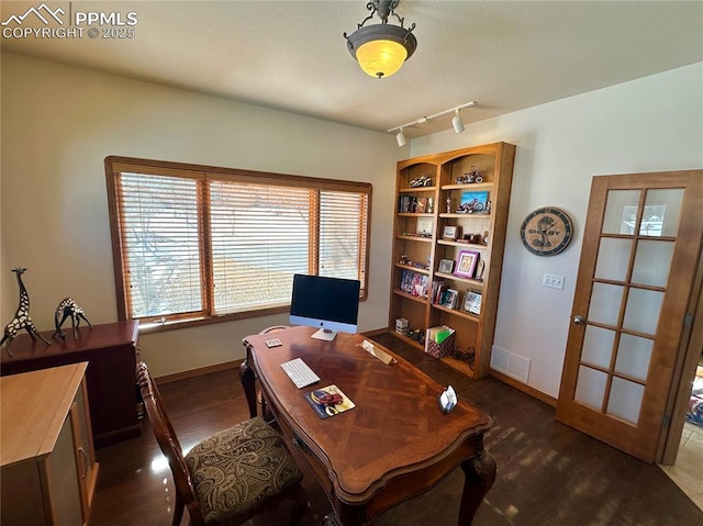 home office with track lighting and dark hardwood / wood-style floors