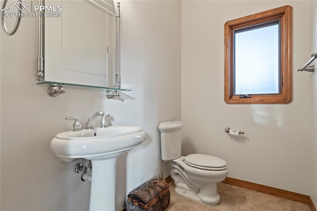 bathroom featuring tile patterned flooring, sink, and toilet