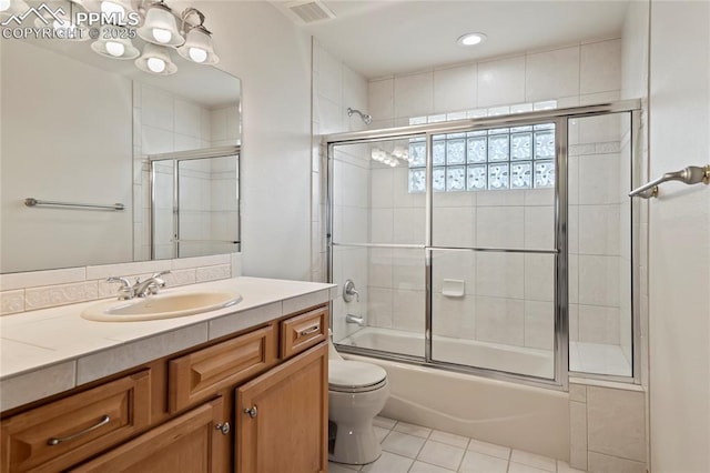 full bathroom featuring vanity, tile patterned floors, enclosed tub / shower combo, and toilet