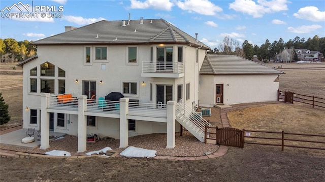 back of house with a balcony