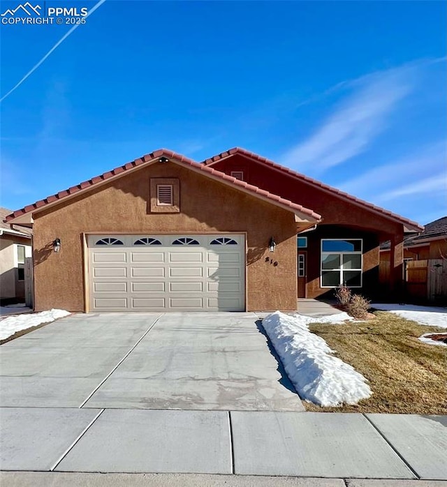 ranch-style home featuring a garage