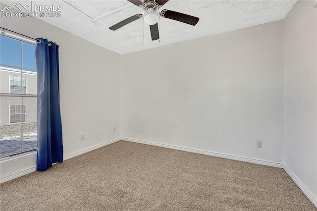 carpeted empty room featuring ceiling fan and a textured ceiling