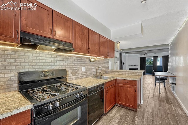 kitchen with black appliances, sink, hardwood / wood-style flooring, ceiling fan, and kitchen peninsula