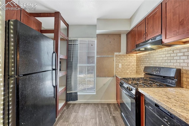 kitchen featuring tasteful backsplash, hardwood / wood-style floors, and black appliances