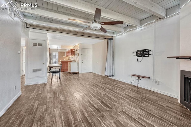 unfurnished living room with hardwood / wood-style floors, beam ceiling, and ceiling fan