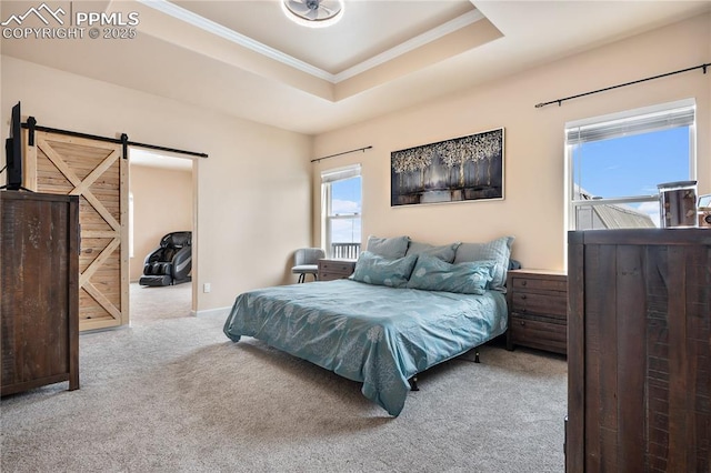 bedroom featuring crown molding, light colored carpet, a tray ceiling, and a barn door