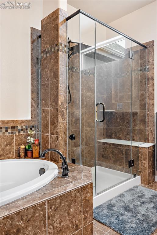 bathroom featuring separate shower and tub