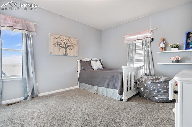 bedroom with multiple windows and carpet flooring