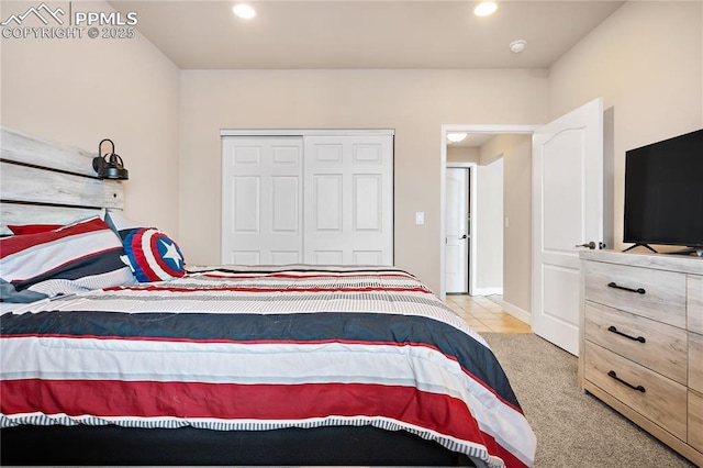 bedroom featuring light carpet and a closet