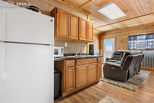 kitchen with wood walls, backsplash, white appliances, wood ceiling, and light wood-type flooring