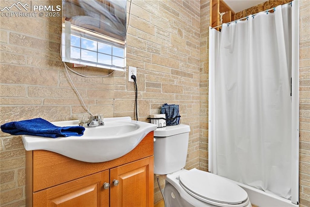 bathroom with vanity, brick wall, a shower with shower curtain, and toilet