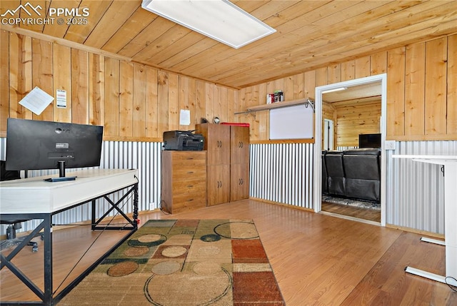 office featuring hardwood / wood-style floors, wooden walls, and wooden ceiling