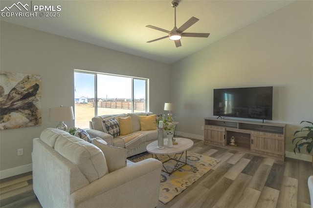 living room featuring vaulted ceiling, dark wood-type flooring, and ceiling fan