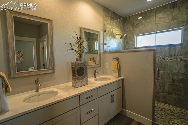 bathroom with vanity, a shower with door, and wood-type flooring