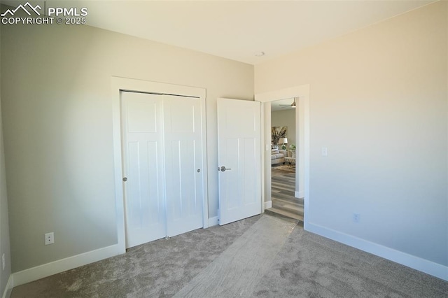 unfurnished bedroom with carpet floors and a closet