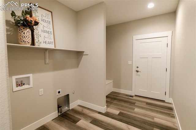 washroom featuring hookup for a washing machine, electric dryer hookup, and hardwood / wood-style floors