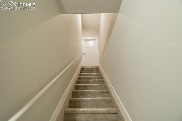 stairway featuring lofted ceiling