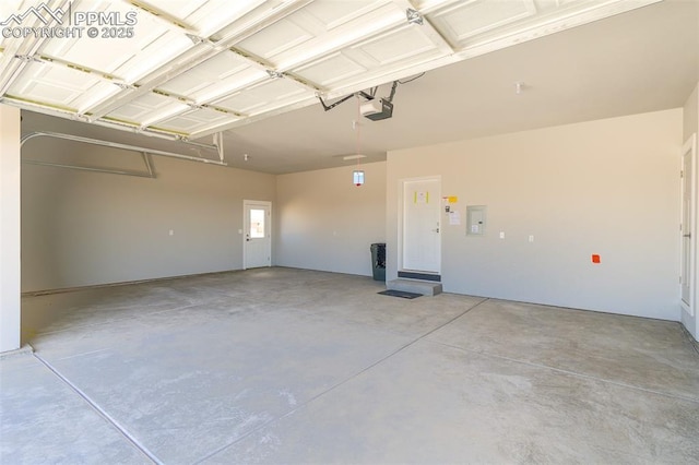 garage featuring a garage door opener and electric panel