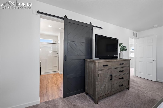 interior space with a barn door and carpet