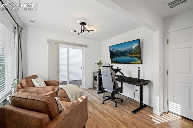 office featuring a notable chandelier and light hardwood / wood-style floors