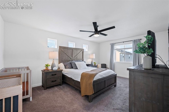 bedroom featuring ceiling fan and dark carpet