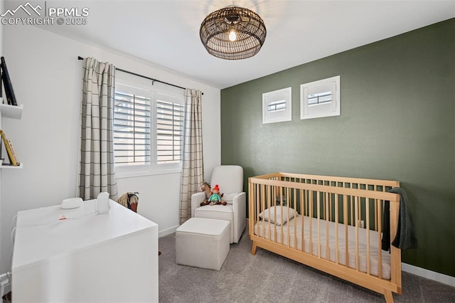 carpeted bedroom featuring a crib