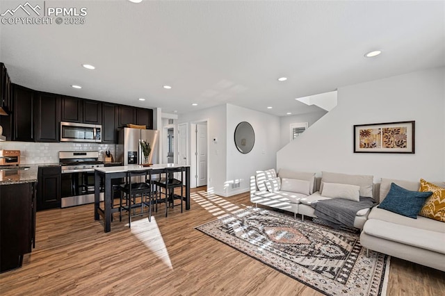 living room with sink and light wood-type flooring