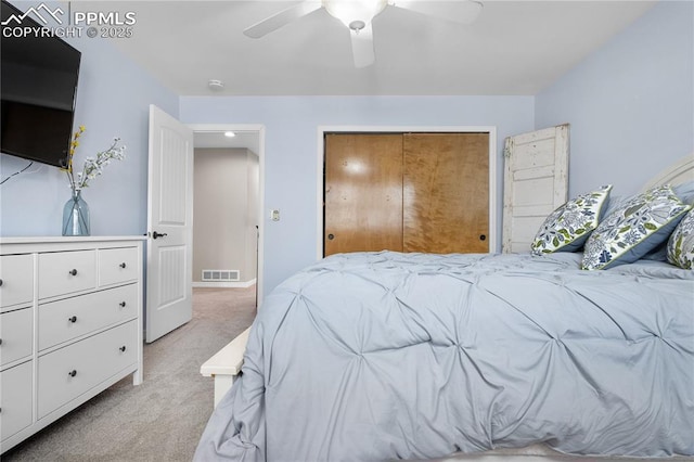 carpeted bedroom with a closet and ceiling fan