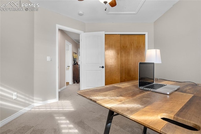 carpeted office space with ceiling fan