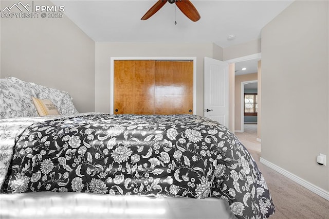 carpeted bedroom with ceiling fan and a closet