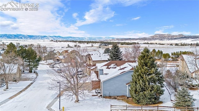 snowy aerial view with a mountain view