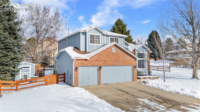 view of snow covered exterior featuring a garage