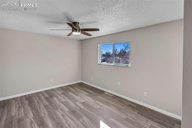 unfurnished room featuring ceiling fan, hardwood / wood-style floors, and a textured ceiling