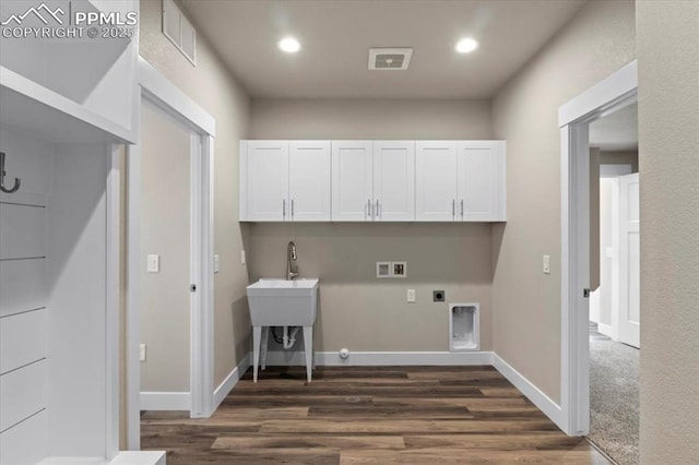 clothes washing area with cabinets, hookup for an electric dryer, washer hookup, and dark hardwood / wood-style flooring