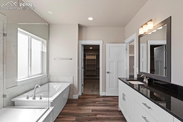 bathroom featuring vanity, wood-type flooring, and independent shower and bath