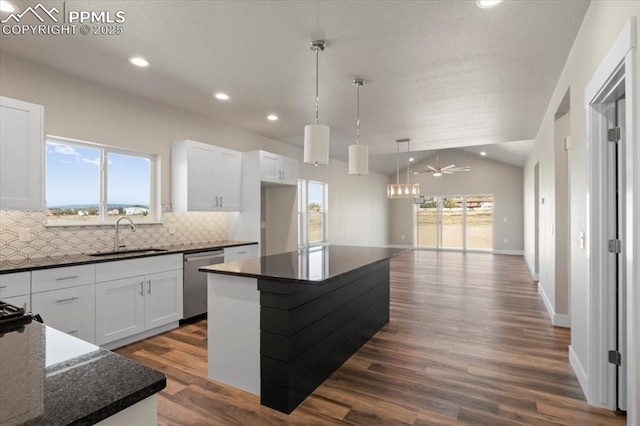 kitchen featuring a center island, sink, and white cabinets