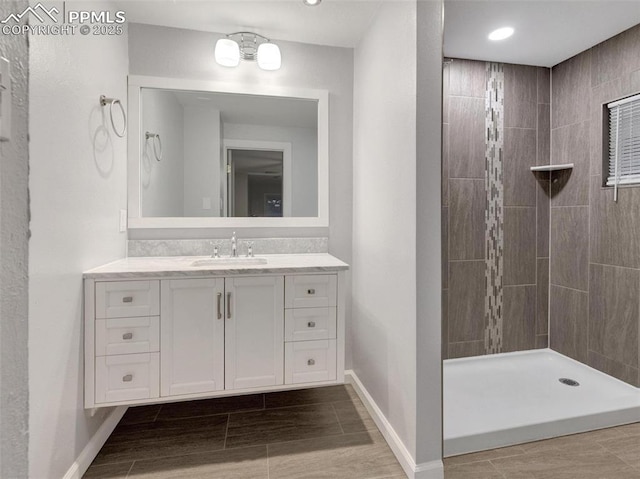 bathroom featuring vanity and a tile shower