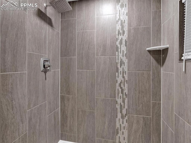 bathroom with a tile shower