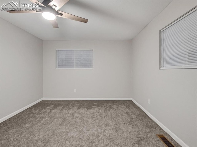 spare room featuring ceiling fan and carpet