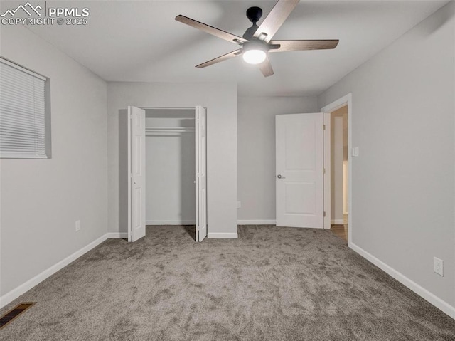 unfurnished bedroom featuring ceiling fan, a closet, and light carpet