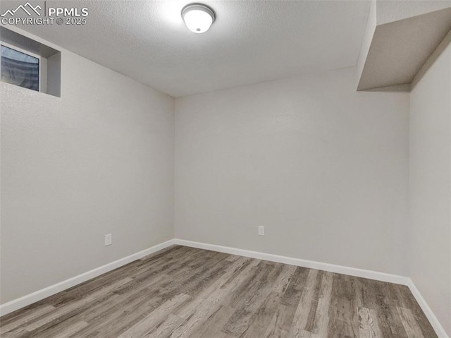 empty room featuring hardwood / wood-style floors and a textured ceiling