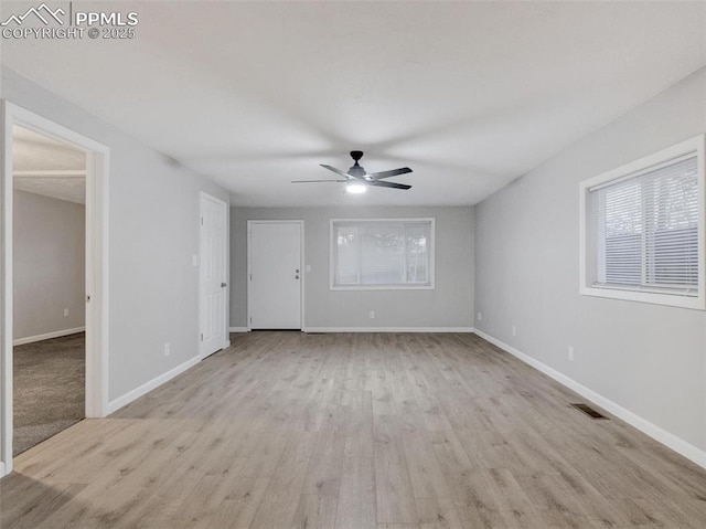 unfurnished room featuring ceiling fan and light wood-type flooring