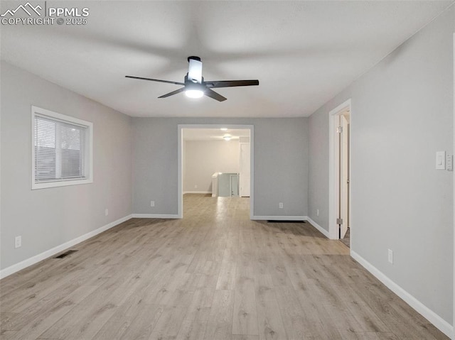 empty room featuring ceiling fan and light wood-type flooring